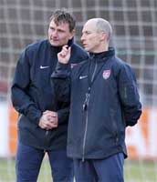 New USMNT assistant Lubos Kubik rubs his hands in grim determination while Coach Bradley discusses crushing somebody's head.