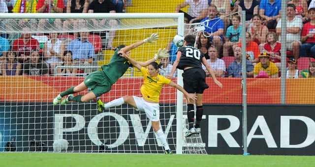 Abby Wambach (r) of team USA scores 2:2 against goalkeeper Andreia and Daiane during the FIFA Women's World Cup at the FIFA Stadium in Dresden, Germany on July 10th, 2011.