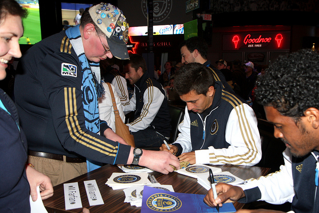 Michael Farfan and Sheanon Williams cranking out signatures