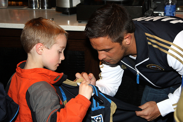 Daniel Cruz signing for a young fan