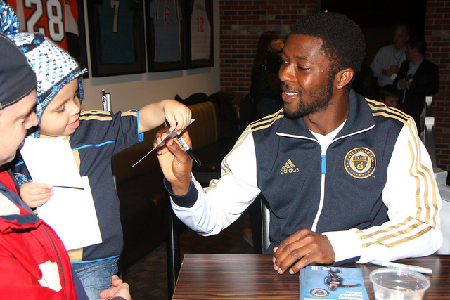 Michael Lahoud making a little guy happy